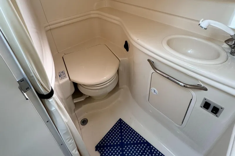Slide: The Image of Compact bathroom in 2004 Sea Ray 320 Sundancer yacht with toilet, sink, and shower. - 19