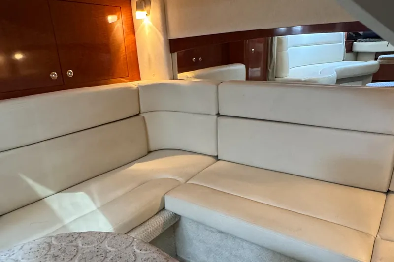 Slide: The Image of Luxurious interior of 2004 Sea Ray 320 Sundancer with cream leather seating. - 20
