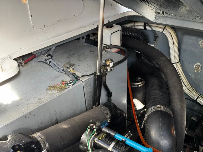 Slide: The Image of Engine compartment of 2004 Sea Ray 320 Sundancer with visible wiring and hoses. - 26