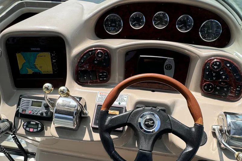 Slide: The Image of 2004 Sea Ray 320 Sundancer helm with navigation system and gauges. - 7