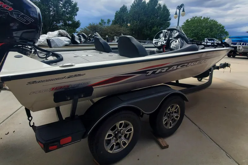 Slide: The Image of 2022 Tracker Pro Team 195XTE fishing boat on trailer, parked outdoors. - 3
