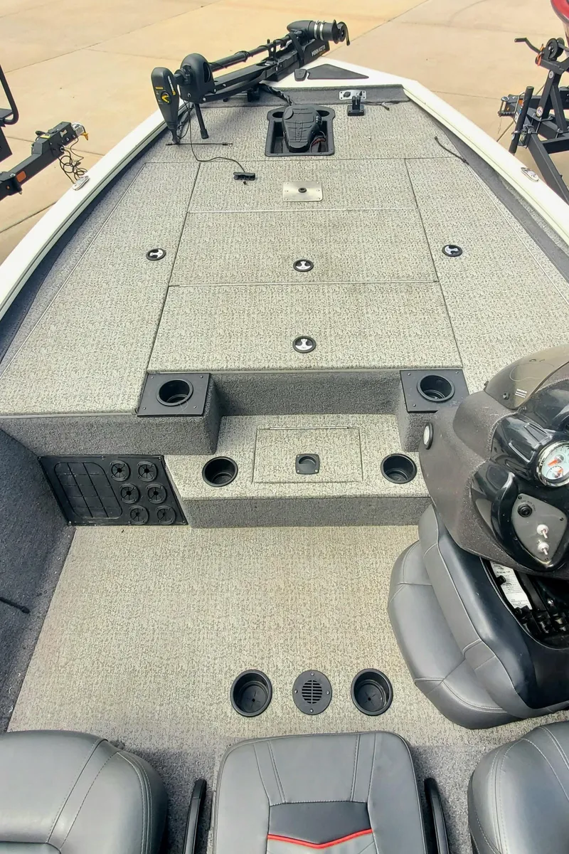 Slide: The Image of 2022 Tracker Pro Team 195XTE boat interior with gray carpet and seating. - 4