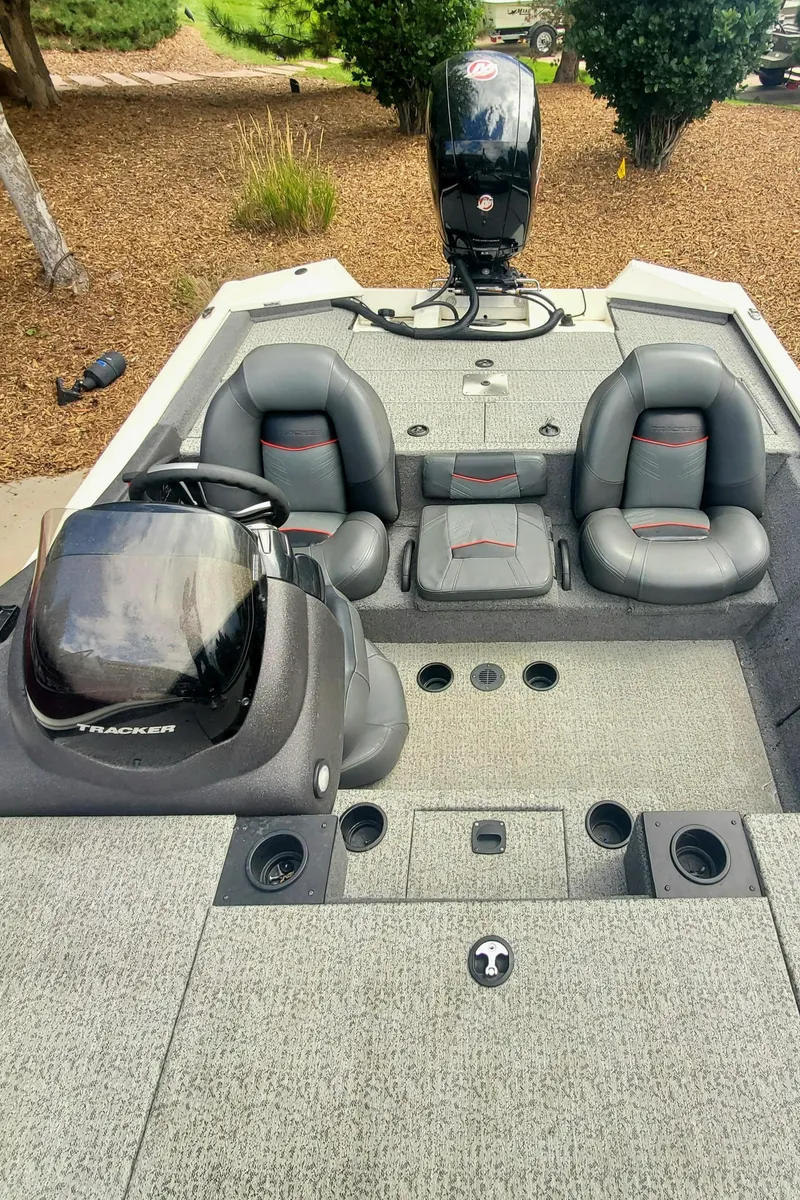 Slide: The Image of 2022 Tracker Pro Team 195XTE boat interior with seating and console. - 5