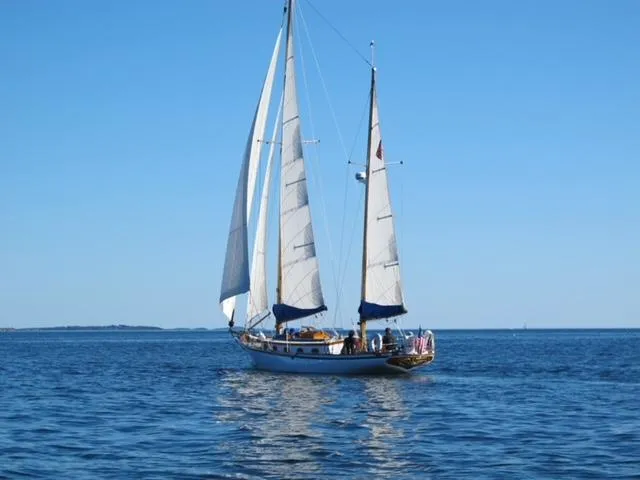 Slide: The Image of 1985 Herreshoff Nereia Molly's Cove 38' sailboat with FRP hull on open water. - 10