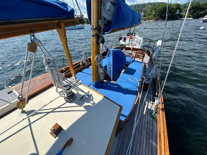 Slide: The Image of 1985 Herreshoff Nereia Molly's Cove 38' sailboat with FRP hull, docked on water. - 12