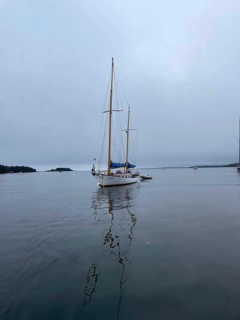 Slide: The Image of Sailboat on calm water, Herreshoff Nereia Molly's Cove 38', 1985 model, overcast sky. - 20