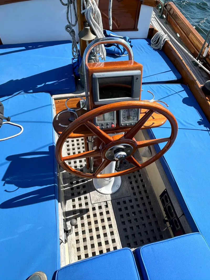 Slide: The Image of 1985 Herreshoff Nereia Molly's Cove 38' sailboat with wooden wheel and blue deck. - 25