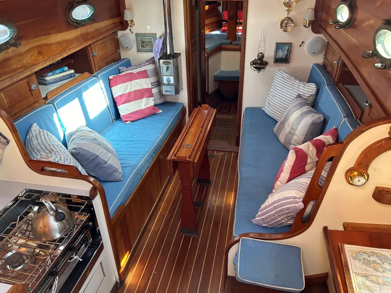 Slide: The Image of Interior of 1985 Herreshoff Nereia Molly's Cove yacht with cozy seating and nautical decor. - 40