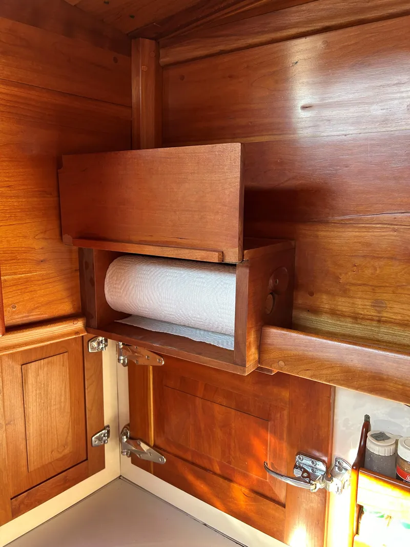 Slide: The Image of Wooden interior of 1985 Herreshoff Nereia Molly's Cove boat with paper towel holder. - 45