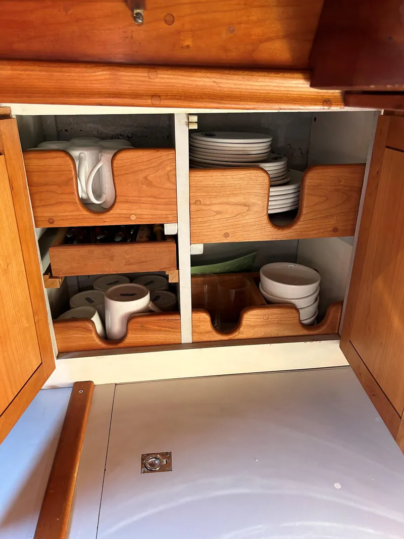 Slide: The Image of Cabinet with organized dishes in 1985 Herreshoff Nereia Molly's Cove 38' yacht. - 47