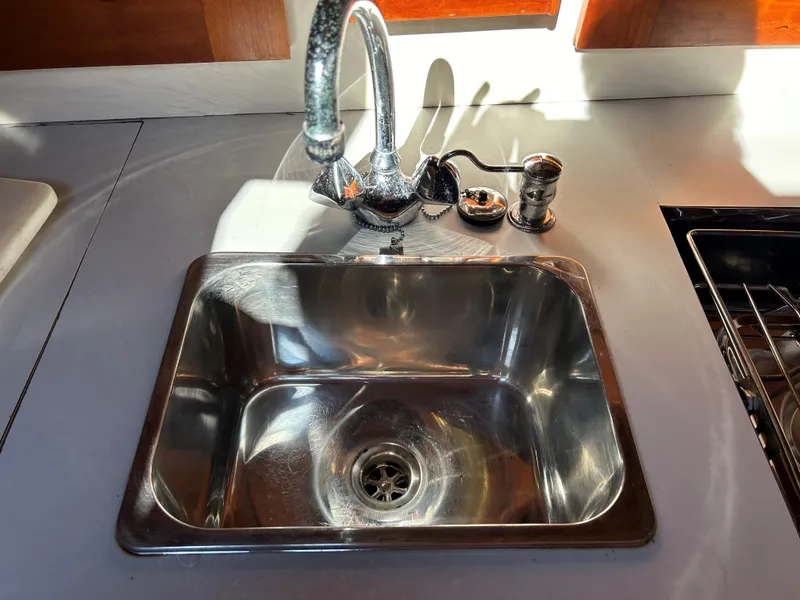 Slide: The Image of Stainless steel sink and faucet in 1985 Herreshoff Nereia Molly's Cove yacht kitchen. - 48