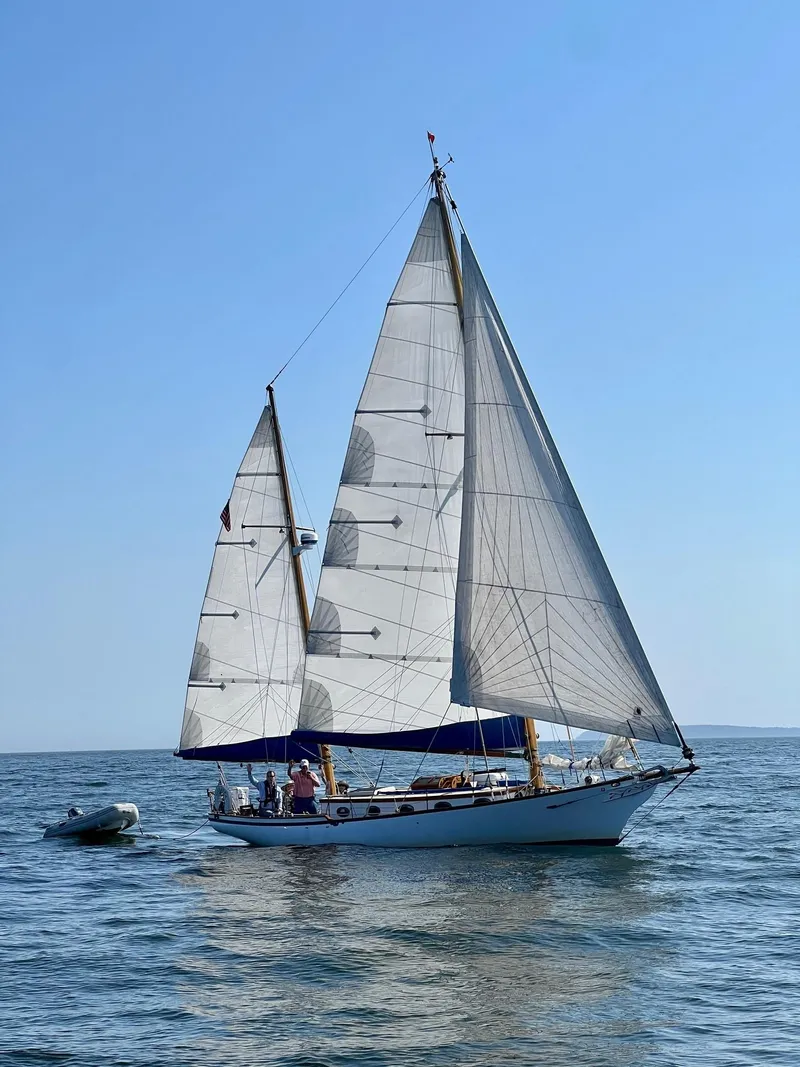 Slide: The Image of 1985 Herreshoff Nereia Molly's Cove 38' sailboat with FRP hull on open water. - 7