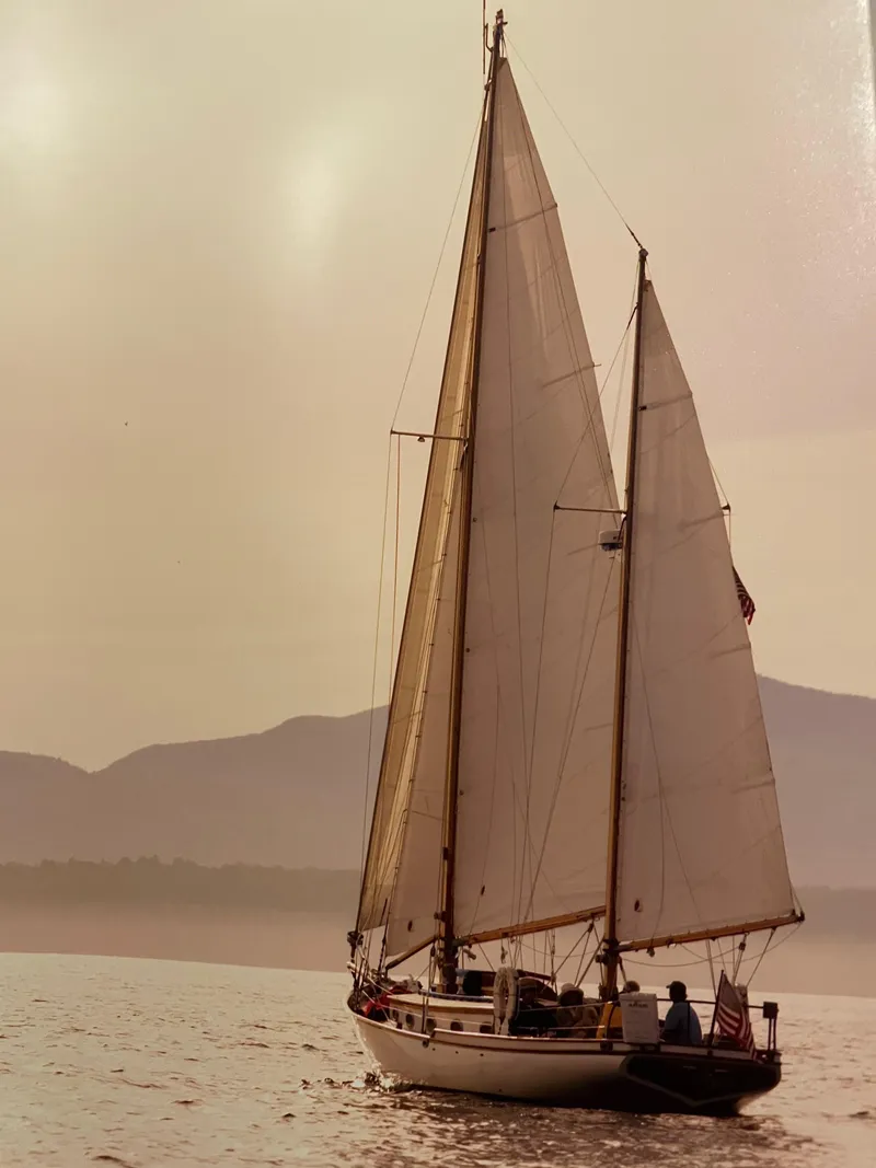 Slide: The Image of 1985 Herreshoff Nereia Molly's Cove 38' sailboat with FRP hull on calm waters. - 9