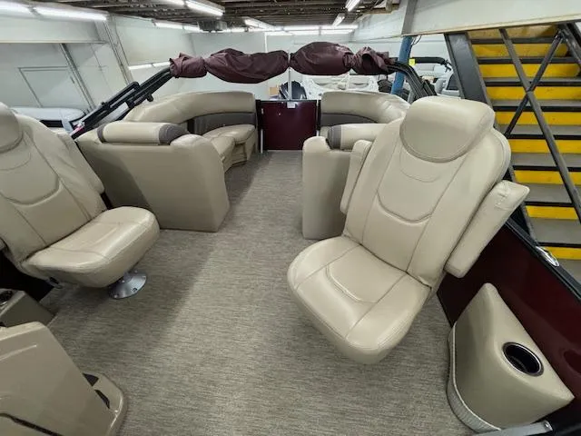 Slide: The Image of 2022 Sylvan Mirage X X3 boat interior with beige seating and carpeted flooring. - 14