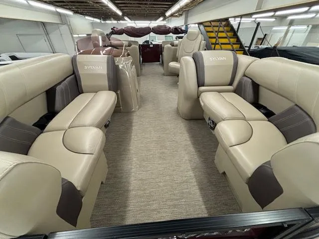 Slide: The Image of 2022 Sylvan Mirage X X3 pontoon boat interior with beige seating. - 17