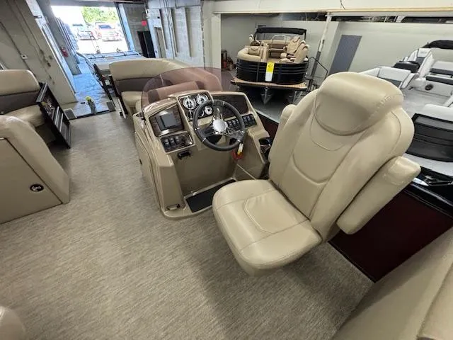 Slide: The Image of 2022 Sylvan Mirage X X3 boat interior with beige captain's chair and control panel. - 2