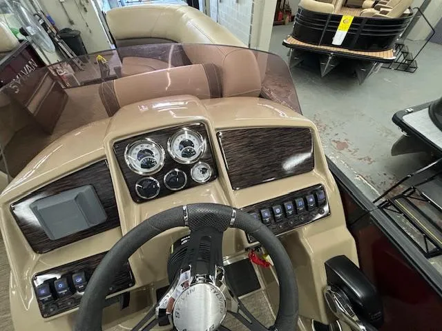 Slide: The Image of 2022 Sylvan Mirage X X3 boat dashboard with steering wheel and control panel. - 4