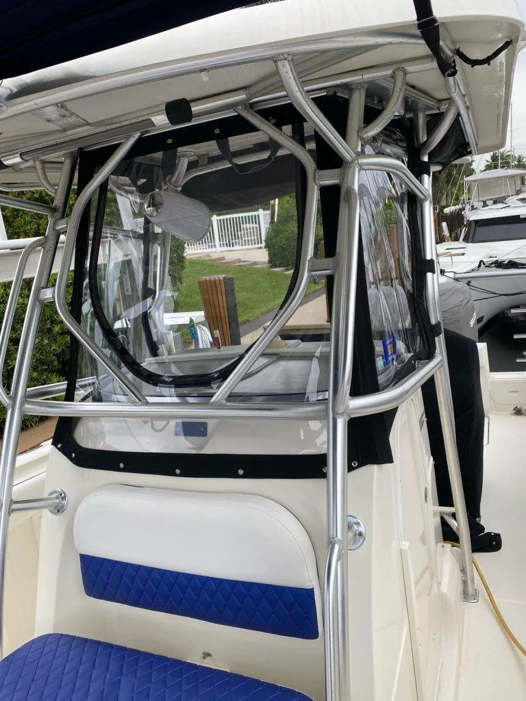 Slide: The Image of 2004 Hydra-Sports Vector 3300 CC boat with blue seating and protective enclosure. - 13