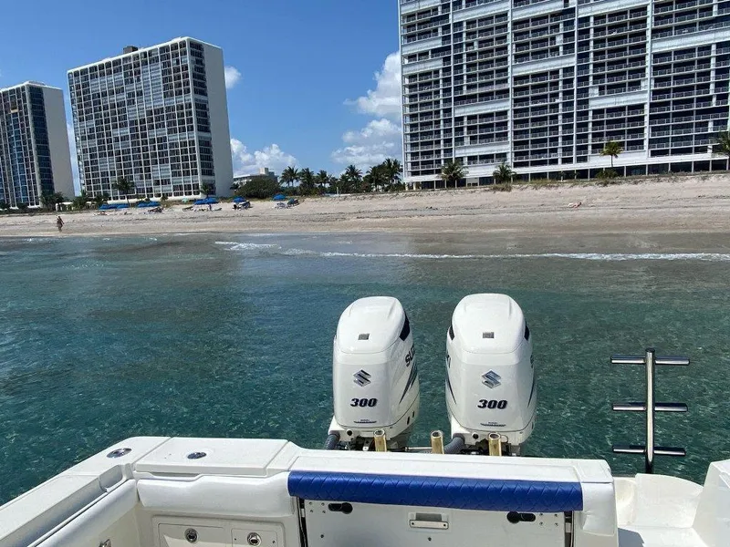 Slide: The Image of 2004 Hydra-Sports Vector 3300 CC boat with twin Suzuki 300 engines near beachfront buildings. - 15