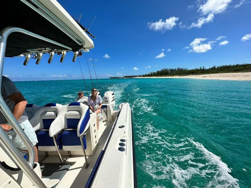 Slide: The Image of 2004 Hydra-Sports Vector 3300 CC cruising in turquoise waters near a sandy beach. - 8