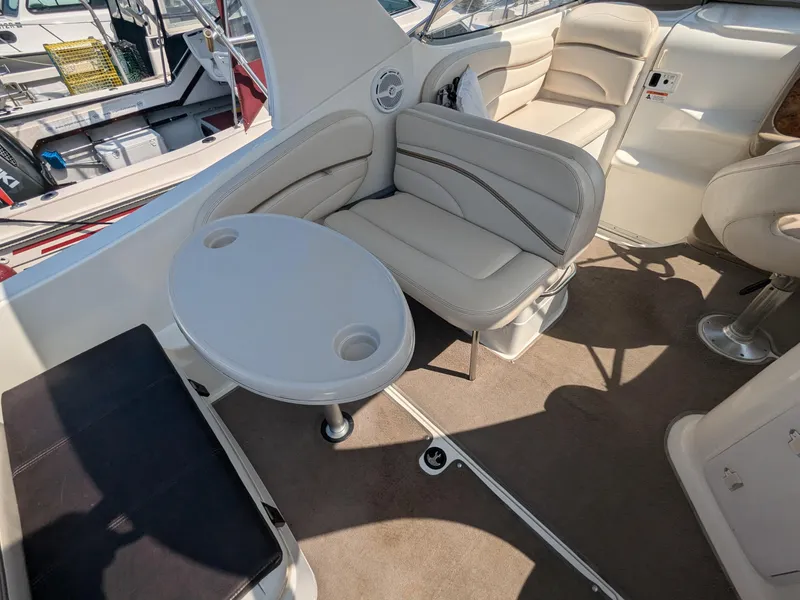 Slide: The Image of 2004 Larson Cabrio 260 boat interior with seating and table. - 11