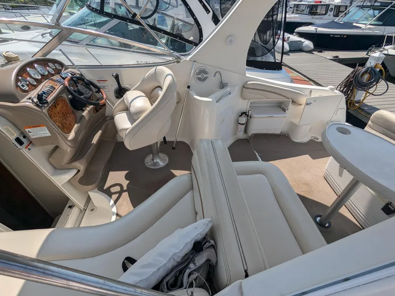 Slide: The Image of 2004 Larson Cabrio 260 boat interior with plush seating and modern dashboard. - 13