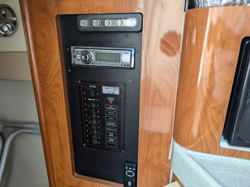 Slide: The Image of Control panel of 2004 Larson Cabrio 260 boat with stereo system and switches. - 20