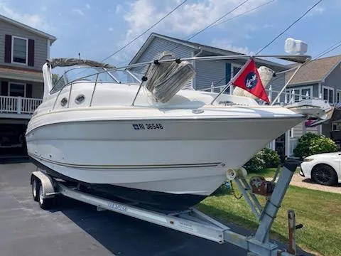 Slide: The Image of 2004 Larson Cabrio 260 boat on trailer in residential driveway. - 28