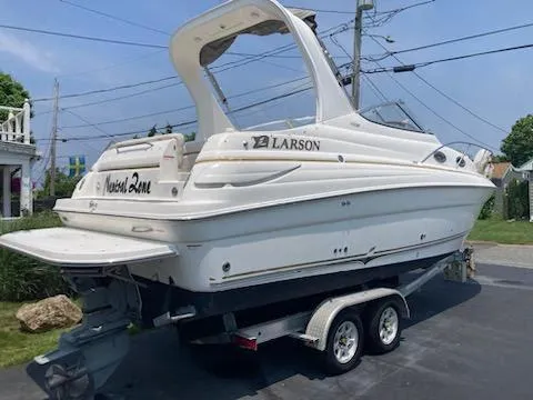 Slide: The Image of 2004 Larson Cabrio 260 boat on trailer, parked outdoors. - 29