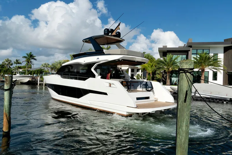 The Image of 2023 Astondoa AS5 yacht cruising near luxury waterfront homes. - 0