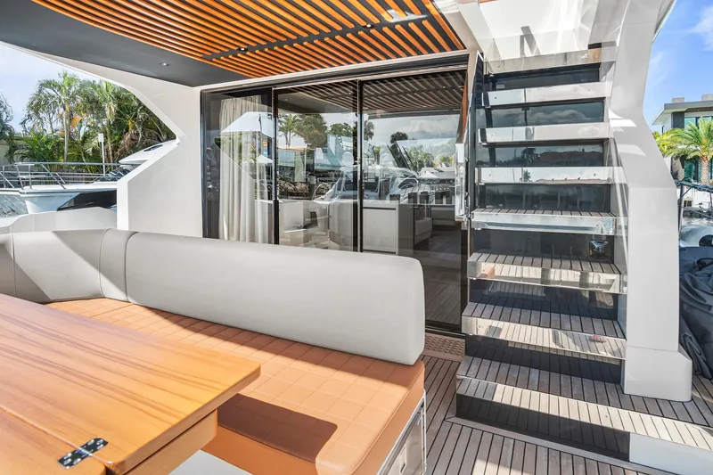 Slide: The Image of Luxurious 2023 Astondoa AS5 yacht deck with modern seating and glass staircase. - 12