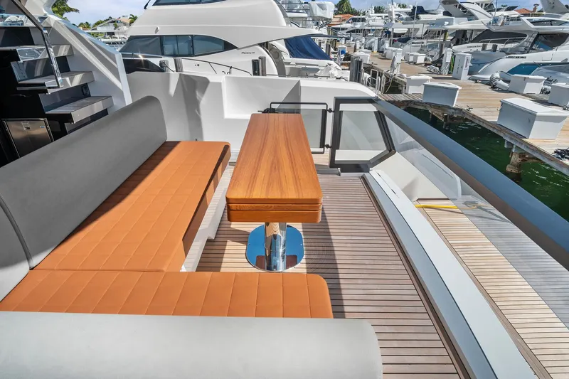 Slide: The Image of Luxury seating area on 2023 Astondoa AS5 yacht deck, featuring sleek design and waterfront view. - 13