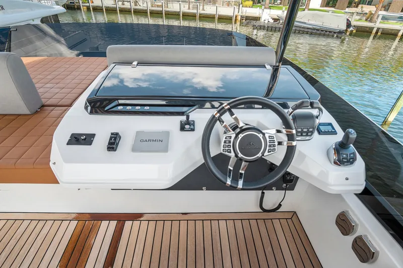 Slide: The Image of 2023 Astondoa AS5 yacht helm with modern controls and wooden deck. - 19