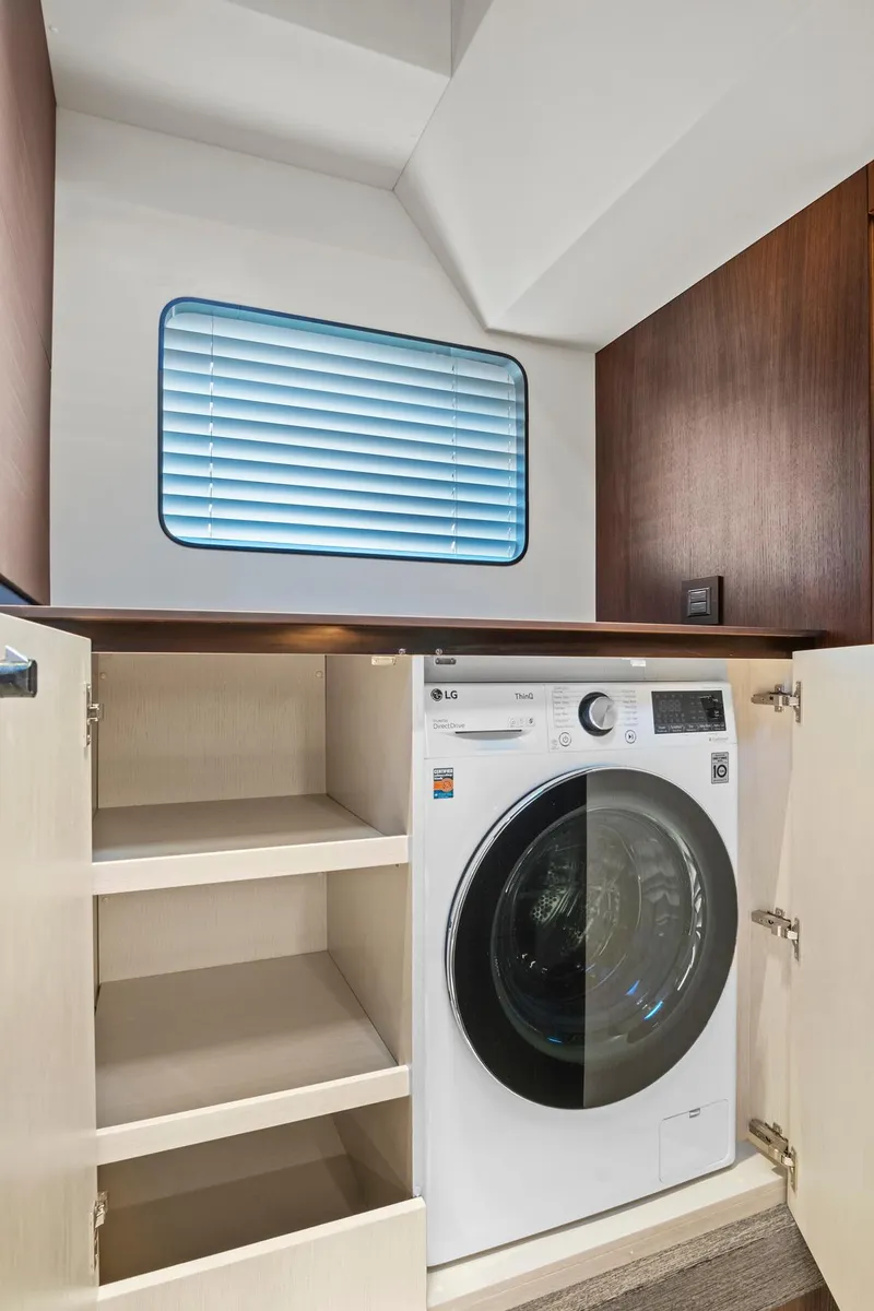 Slide: The Image of 2023 Astondoa AS5 yacht interior with built-in washer and storage shelves. - 33