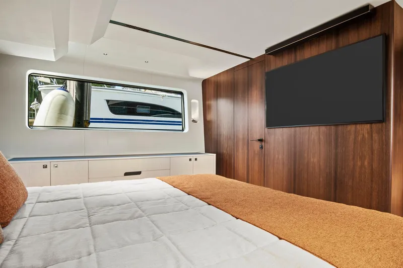 Slide: The Image of Luxurious 2023 Astondoa AS5 yacht bedroom with modern wood paneling and large window. - 35