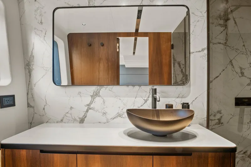 Slide: The Image of Luxurious bathroom in 2023 Astondoa AS5 yacht with marble walls and modern vessel sink. - 38