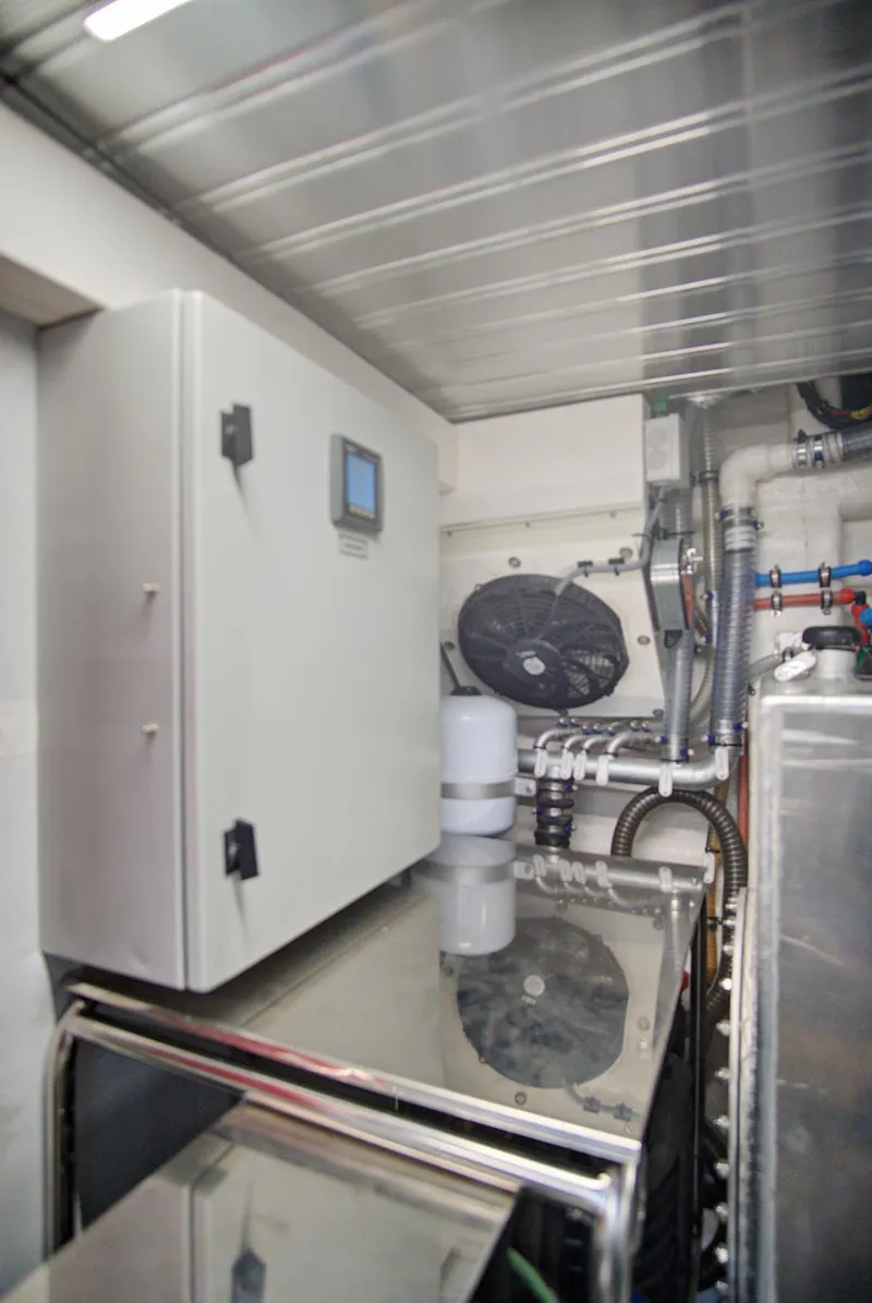 Slide: The Image of Engine room of 2023 Astondoa AS5 yacht with control panel and piping. - 44