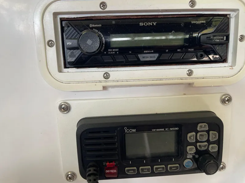 Slide: The Image of 2007 Pro-Line 25 Sport boat dashboard with Sony stereo and Icom marine radio. - 12