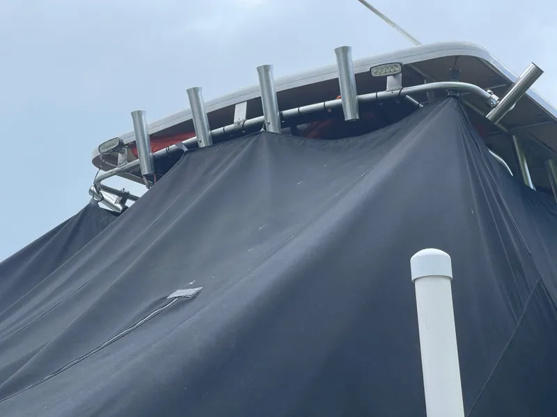 Slide: The Image of 2007 Pro-Line 25 Sport boat with a black cover and rod holders. - 17