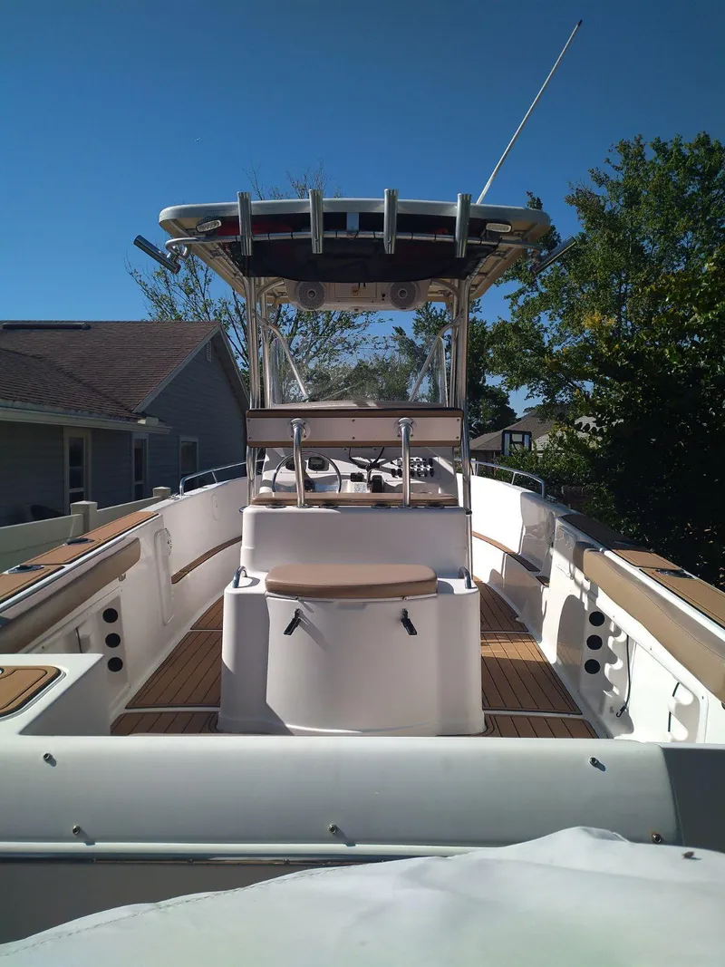 Slide: The Image of 2007 Pro-Line 25 Sport boat with center console and T-top, docked outdoors. - 4