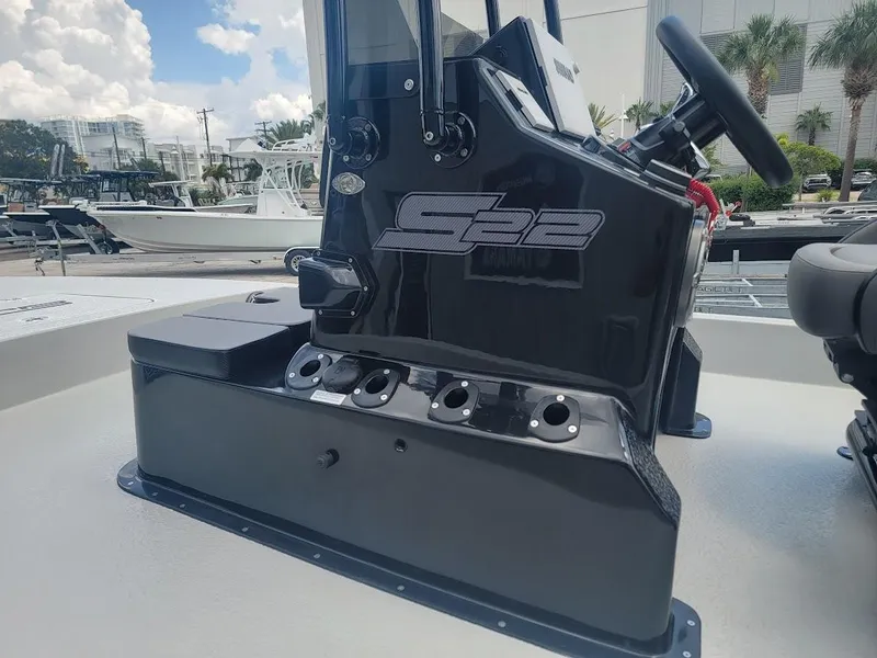 Slide: The Image of 2025 SCB S22 boat console with steering wheel, docked under a cloudy sky. - 11
