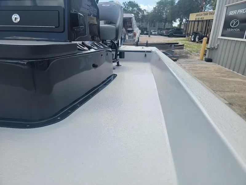 Slide: The Image of 2025 SCB S22 boat deck with sleek black console and outdoor setting. - 16