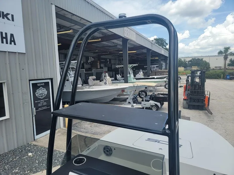Slide: The Image of SCB S22 boat at dealership, showcasing modern design and outdoor storage area. - 25