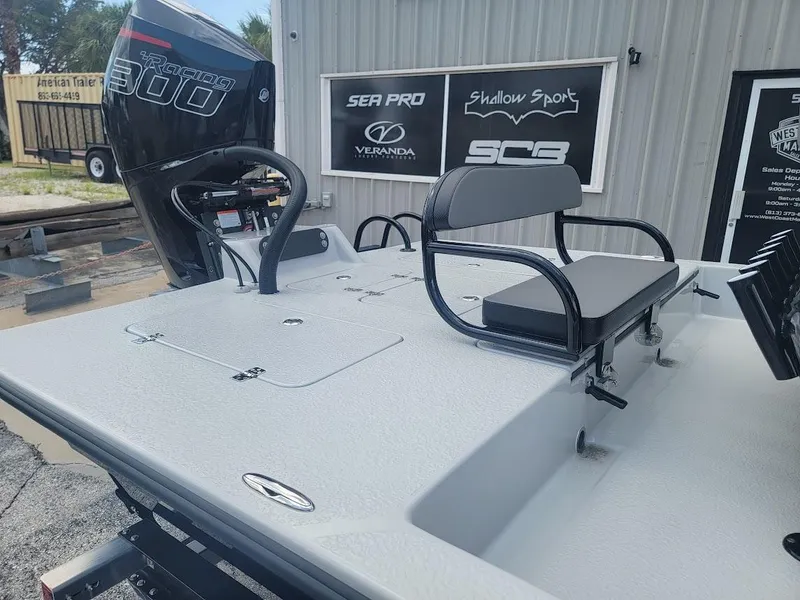 Slide: The Image of 2025 SCB S22 boat with seating and powerful outboard motor, displayed outside dealership. - 3