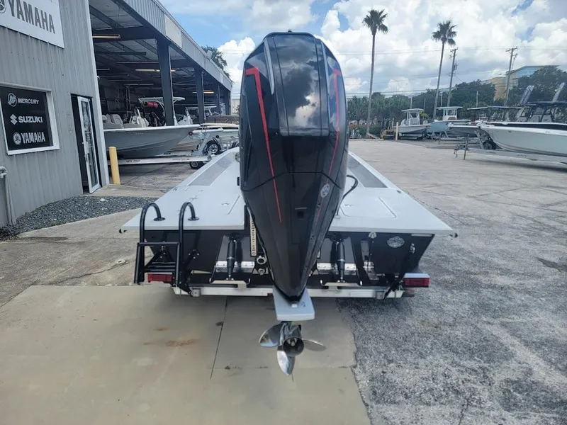 Slide: The Image of 2025 SCB S22 boat with powerful outboard motor at a marina. - 6