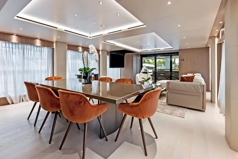 Slide: The Image of Luxurious yacht interior with elegant dining area, modern decor, and plush seating, 2023 Custom Line 106'. - 10
