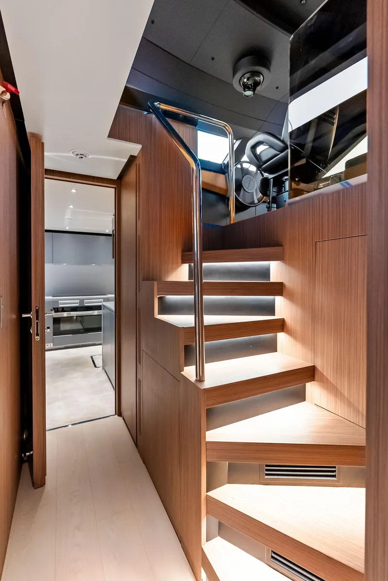 Slide: The Image of Luxurious interior of 2023 Custom Line 106' yacht with modern wooden staircase. - 16