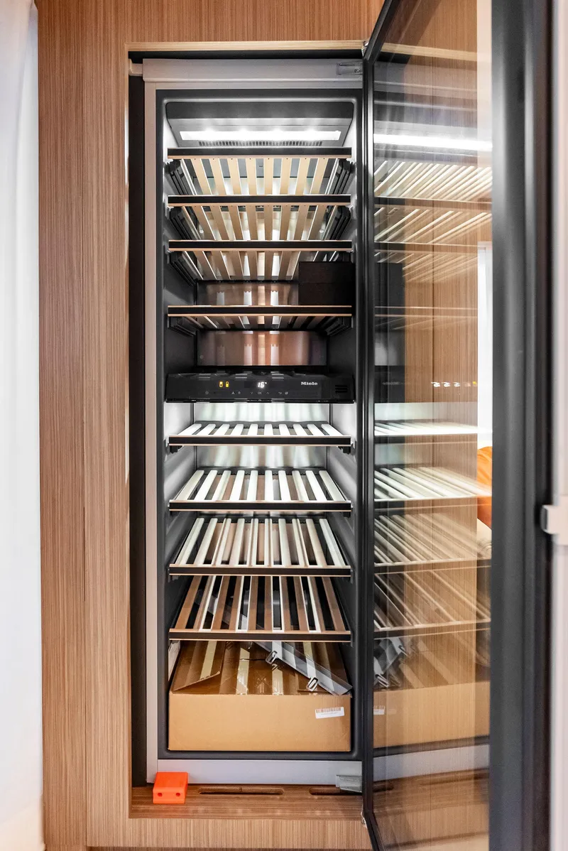 Slide: The Image of Modern wine cooler with wooden shelves on a Custom Line 106' yacht, 2023 model. - 17