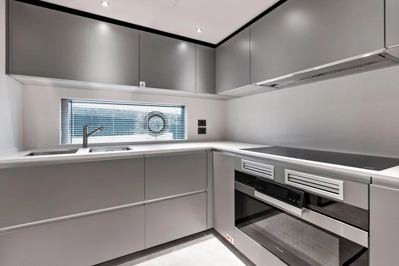 Slide: The Image of Modern kitchen in 2023 Custom Line 106' yacht with sleek gray cabinetry and appliances. - 22