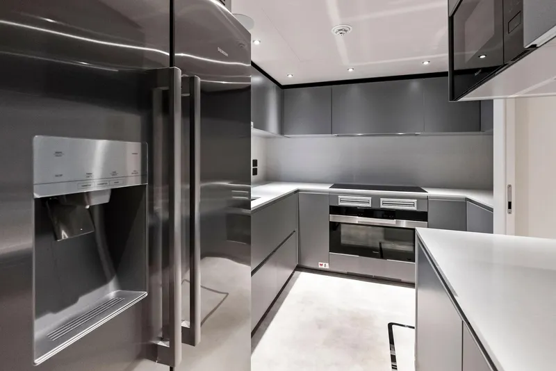 Slide: The Image of Modern kitchen in 2023 Custom Line 106' yacht with sleek appliances and minimalist design. - 24